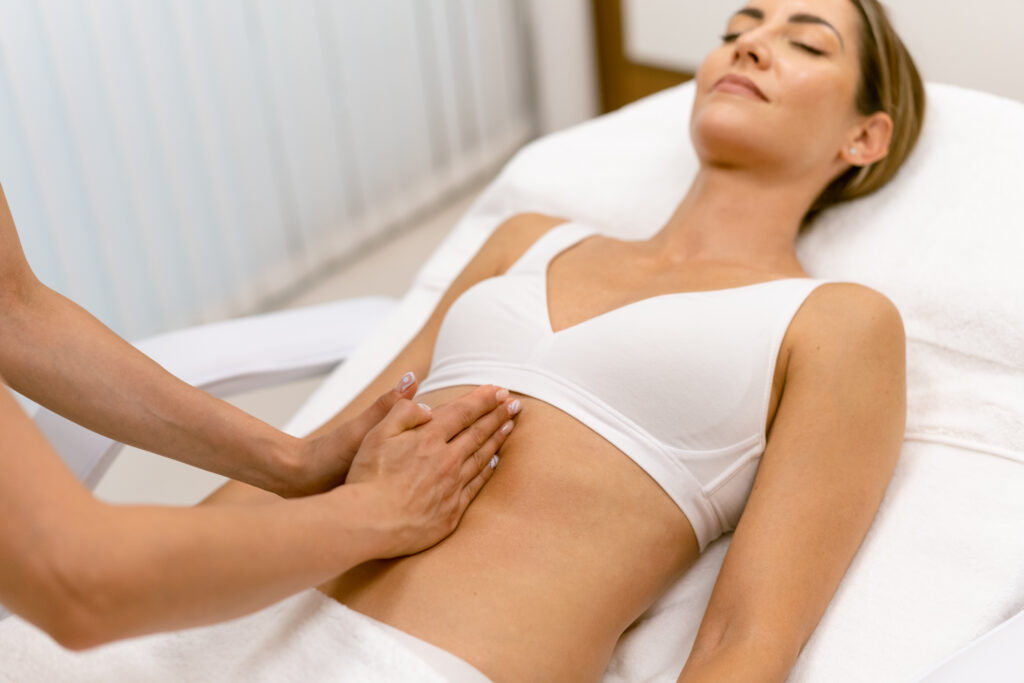 Middle Aged Woman Having A Belly Massage In A Beauty Salon.