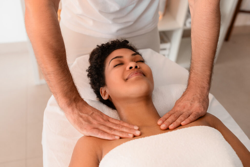 Woman Receiving A Neck Massage From Therapist